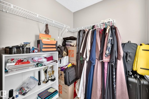 Built-in wire shelving and a white bookcase provide organizational solutions - 12035 168 Avenue Nw, Edmonton, AB 