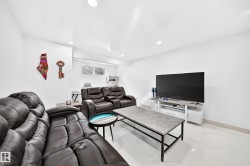 Recessed lighting illuminating a spacious room with light-toned flooring - 