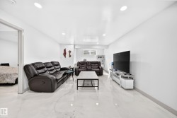 Recessed lighting illuminates this expansive space featuring light-toned tile flooring and a neutral color palette - 