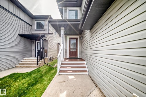 Front entry with wood-finish steps and a covered porch - 12035 168 Avenue Nw, Edmonton, AB 