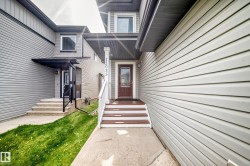 Front entry with wood-finish steps and a covered porch - 