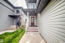 Front entry with wood-finish steps and a covered porch - 12035 168 Avenue Nw, Edmonton, AB 