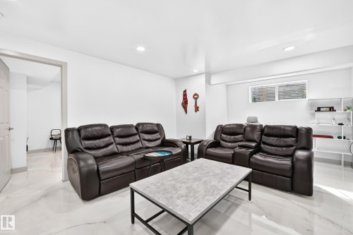 Recessed lighting throughout, white walls, and a window with horizontal blinds - 12035 168 Avenue Nw, Edmonton, AB 