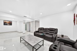 Recessed lighting, tile flooring, solid white walls, and white trim - 