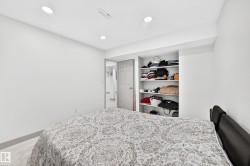 Recessed lighting illuminating a bedroom with built-in shelving - 