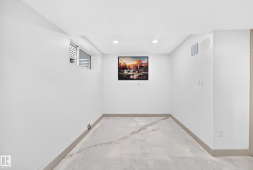 Recessed lighting, wood-finish baseboards, and a window with horizontal blinds - 12035 168 Avenue Nw, Edmonton, AB 