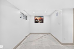 Recessed lighting, wood-finish baseboards, and a window with horizontal blinds - 