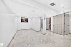 Polished flooring, recessed lighting, white walls, and paneled doors - 