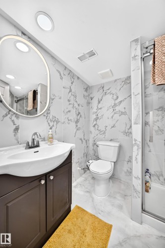 Vanity with integrated sink, chrome-finish faucet, and dark wood-finish cabinetry - 12035 168 Avenue Nw, Edmonton, AB 