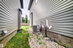 Vinyl siding exterior with a rock-lined foundation - 