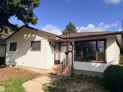 White horizontal siding exterior with brown trim windows - 13219 107 Street Nw, Edmonton, AB 