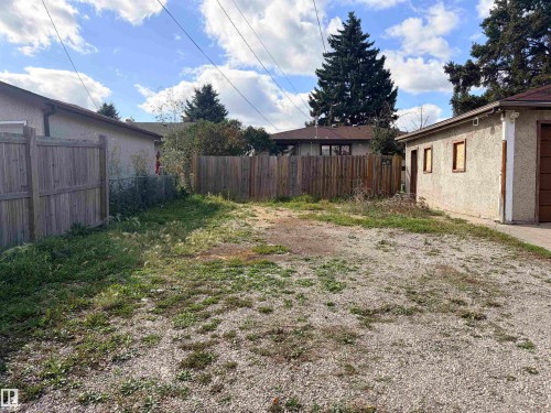 Gravel lot with perimeter fencing and a detached garage structure - 13219 107 Street Nw, Edmonton, AB 