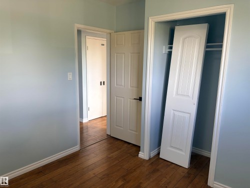 Wood-finish flooring throughout Bedroom 2 upstairs - 13219 107 Street Nw, Edmonton, AB 