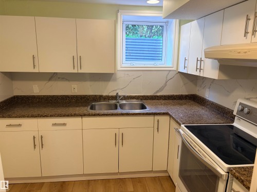White cabinetry with brushed nickel hardware Basement kitchen - 13219 107 Street Nw, Edmonton, AB 