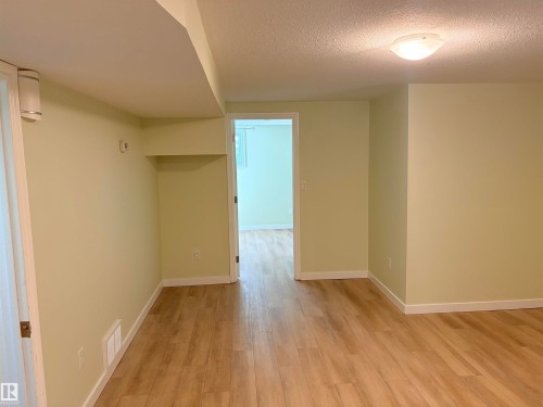 Wood-finish flooring throughout, neutral wall tones, and recessed ceiling elements - 13219 107 Street Nw, Edmonton, AB 