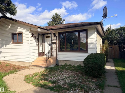 White siding exterior with a brown trim roof - 13219 107 Street Nw, Edmonton, AB 