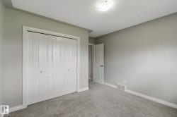 Recessed ceiling light, neutral wall color, plush carpet flooring, bi-fold closet doors, and white trim - 