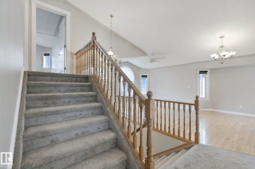 Carpeted staircase with wood banister - 16807 78 Street Nw, Edmonton, AB 