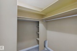 Built-in shelving, hanging rod, and recessed ceiling details - 