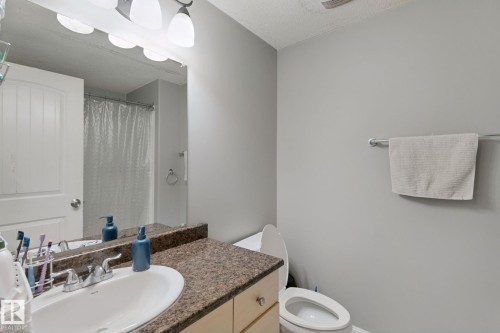 Vanity with a speckled countertop, integrated sink, and dual-handle faucet - 16807 78 Street Nw, Edmonton, AB 