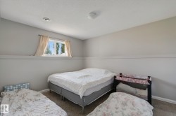Wall-to-wall carpeting with a neutral finish, featuring a window with a valance and ceiling-mounted lighting - 
