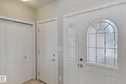 Front entry featuring an arched leaded glass door and a coordinating sidelight - 16807 78 Street Nw, Edmonton, AB 