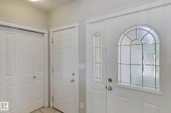 Front entry featuring an arched leaded glass door and a coordinating sidelight - 