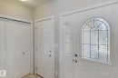 Front entry featuring an arched leaded glass door and a coordinating sidelight - 16807 78 Street Nw, Edmonton, AB 
