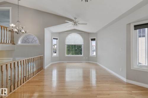 Vaulted ceiling with a ceiling fan, hardwood flooring, and a bay window - 16807 78 Street Nw, Edmonton, AB 