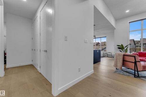 Open-concept design featuring wood-finish flooring, recessed lighting, and large windows - 1409 Graydon Hill Way Sw, Edmonton, AB 