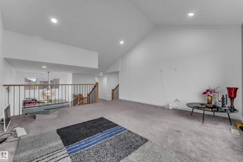 Vaulted ceiling, recessed lighting, carpet flooring, open railing, and natural light from window - 1409 Graydon Hill Way Sw, Edmonton, AB 