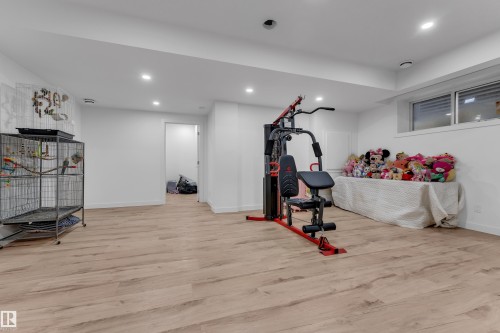 Recessed lighting, wood-finish flooring, and white walls - 1409 Graydon Hill Way Sw, Edmonton, AB 