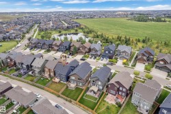 Residential neighborhood setting with varied architectural styles, featuring a prominent pond and green spaces - 