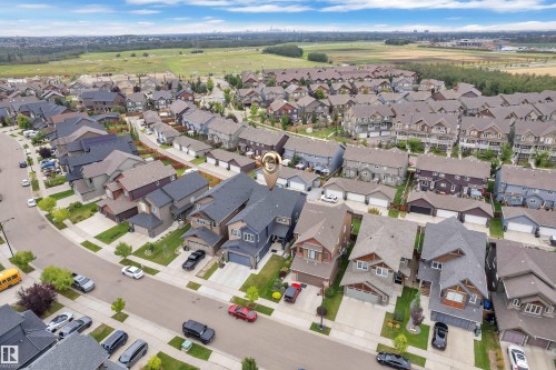 Residential neighborhood with detached homes, attached garages, and paved driveways - 1409 Graydon Hill Way Sw, Edmonton, AB 