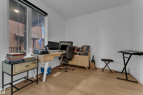 Bright room with wood-finish flooring and white walls - 1409 Graydon Hill Way Sw, Edmonton, AB 