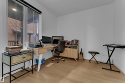 Bright room with wood-finish flooring and white walls - 