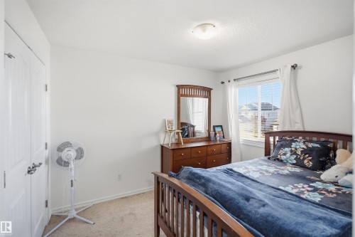 White paneled door, carpeted flooring, and a window with blinds - 1523 36 Avenue Nw, Edmonton, AB 