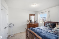 White paneled door, carpeted flooring, and a window with blinds - 