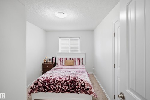 White interior walls, ceiling-mounted light fixture, window with blinds, and white paneled door - 1523 36 Avenue Nw, Edmonton, AB 