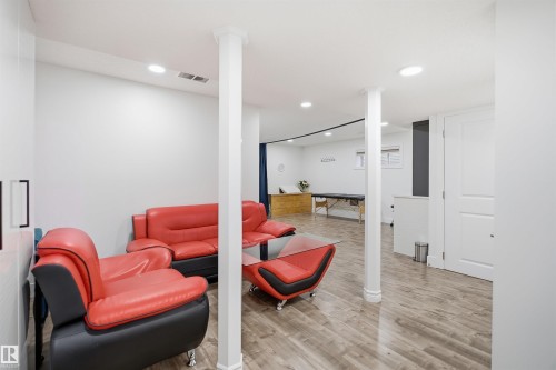 Recessed lighting illuminates the wood-finish flooring - 1523 36 Avenue Nw, Edmonton, AB 