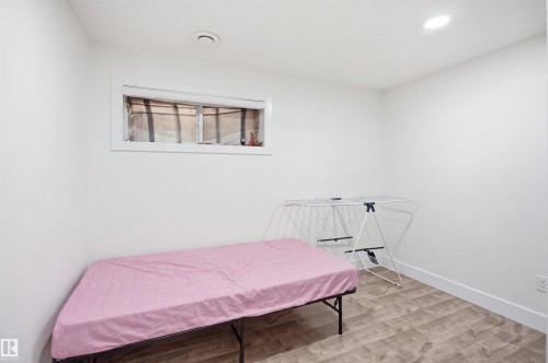 Recessed ceiling lighting, wood-finish flooring, and a window with white trim - 1523 36 Avenue Nw, Edmonton, AB 