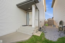Front entrance with concrete steps and covered porch - 