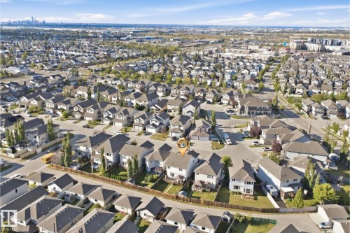 Aerial perspective of a residential neighborhood featuring detached homes and tree-lined streets - 1523 36 Avenue Nw, Edmonton, AB 