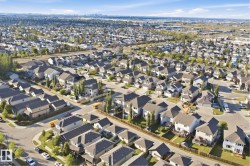Expansive residential neighborhood with varied architectural styles under a clear sky - 
