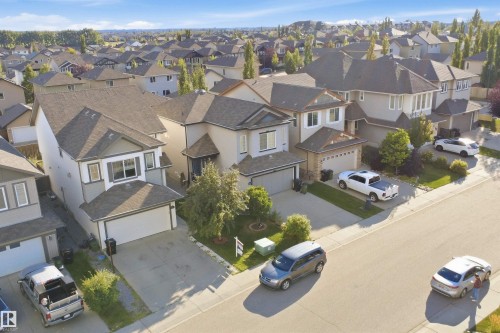 Spacious residential street with detached homes featuring multi-car driveways and attached garages - 1523 36 Avenue Nw, Edmonton, AB 