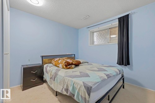 Light blue walls with a textured ceiling - 3216 138 Avenue Nw, Edmonton, AB 