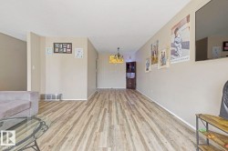 Wood-finish flooring throughout, neutral wall paint, and recessed ceiling lighting - 