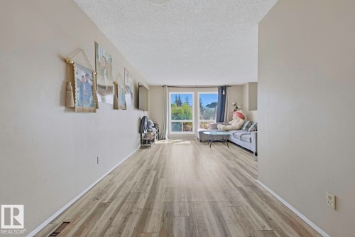 Wood-finish flooring throughout, paired with light-toned walls - 3216 138 Avenue Nw, Edmonton, AB 