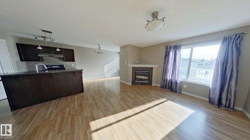 7665 Schmid Crescent Northwest, Edmonton, AB - Indoor Photo Showing Kitchen With Fireplace