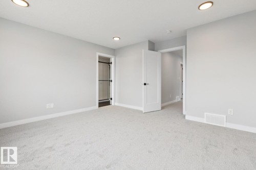 Neutral carpeting, recessed lighting, and white trim - 72 Maple Crescent, Gibbons, AB 